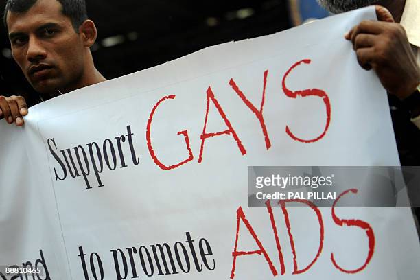 Activists from the Students Islamic Organisation of India hold banners as they protest against an Indian court ruling to decriminalise gay sex, in...
