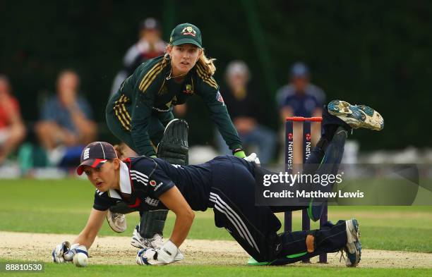 Jodie Fields of Australia edges the ball past Sarah Taylor of England during the Women's One Day International match bewteen England and Australia at...