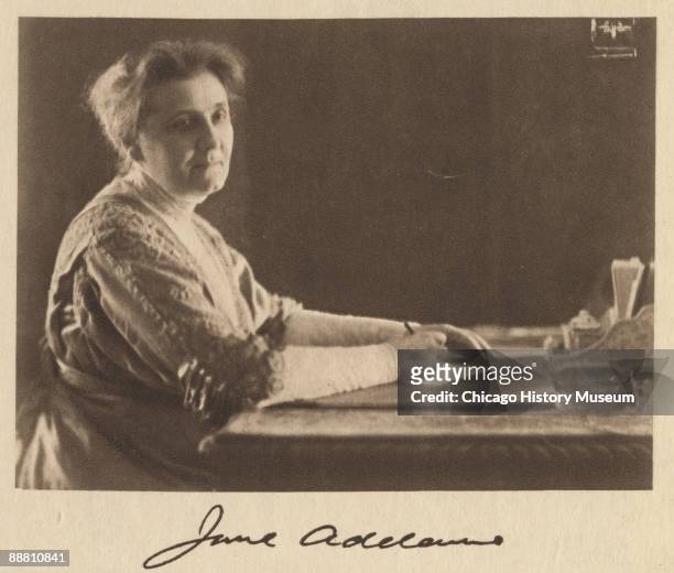 Portrait of Nobel peace prize winner and social activist Jane Addams , penning a letter at her desk, Chicago, IL, ca. 1890s.
