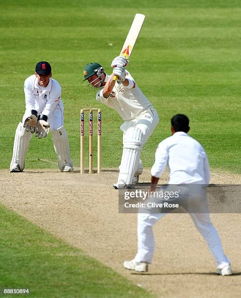 Michael Clarke of Australia hits out off the bowling of Adil Rashid of England Lions as wicket keeper Steve Davies looks on during the Ashes warm-up...