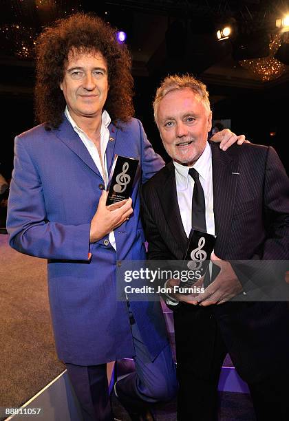 Musicians Brian May and Roger Taylor from Queen with their Ambassadors of Rock award during the O2 Silver Clef Awards 2009 at the London Hilton on...