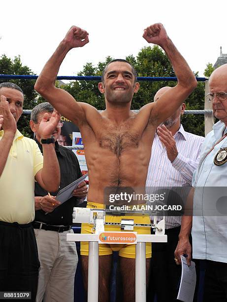 French former super-bantamweight WBA champion Mahyar Monshipour gestures as he weighs-in on July 3, 2009 in Poitiers, central France, on the eve of...