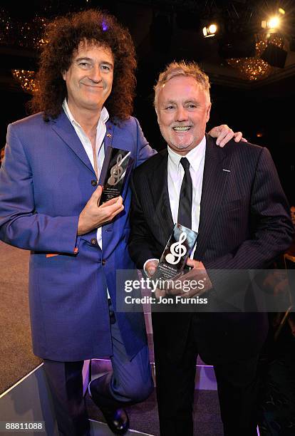Musicians Brian May and Roger Taylor from Queen with their Ambassadors of Rock award during the O2 Silver Clef Awards 2009 at the London Hilton on...