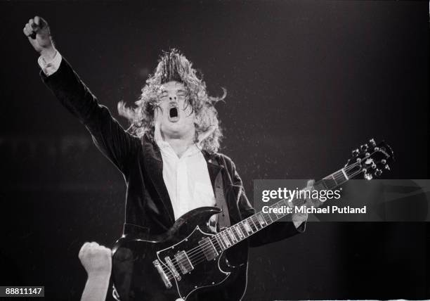 Guitarist Angus Young performing with heavy rock group AC/DC on tour in the UK, 1981.
