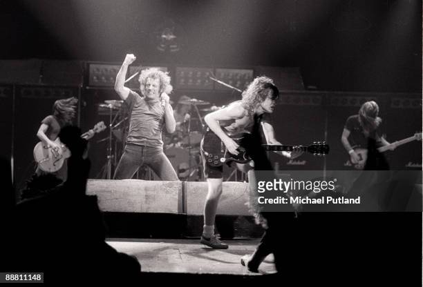 Heavy rock group AC/DC performing on tour in Europe, 1980. Left to right: rhythm guitarist Malcolm Young, singer Brian Johnson, drummer Phil Rudd,...