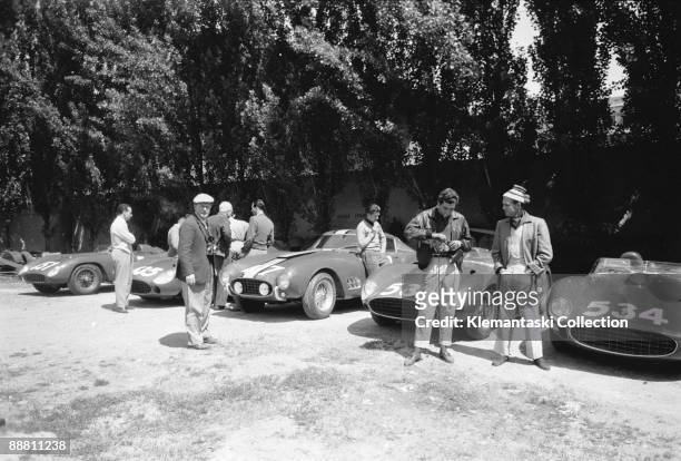 Before The Mille Miglia; Maranello, May 1957. The Ferrari team lined up in the factory yard before the 1957 Mille Miglia: Olivier Gendebien leans...