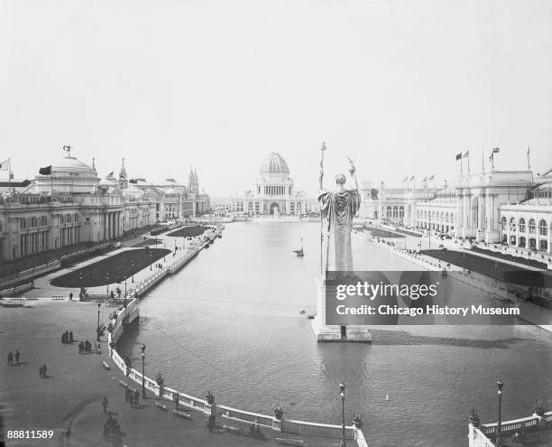 People stroll along the walkways along the Court of Honor, with the Statue of the Republic dominating the center basin at the Chicago World's...