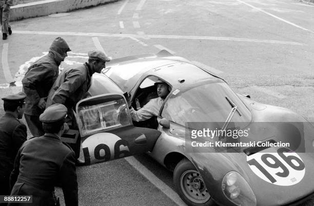 The Targa Florio; Sicily, May 8, 1966. The late Giancarlo Baghetti has a quick word at the Polizzi service depot. He is driving a Ferrari Dino 206S...