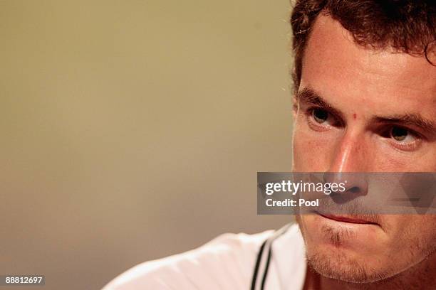 Andy Murray of Great Britain looks despondent as he attends a press conference after defeat during the men's singles semi final match against Andy...