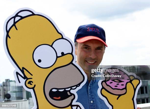 The voices behind The Simpsons, Dan Castellaneta with cutout of Homer Simpson, London, 16th August 2000.