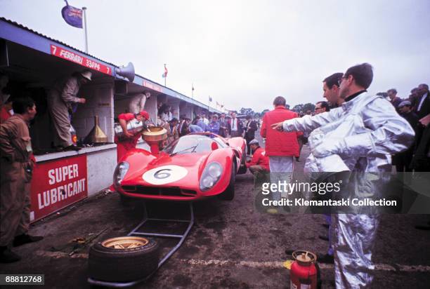 The BOAC International 500 Race, Brands Hatch, July 30, 1967. A rather frantic-looking pit stop for the 330P4 of Chris Amon and Jackie Stewart, which...