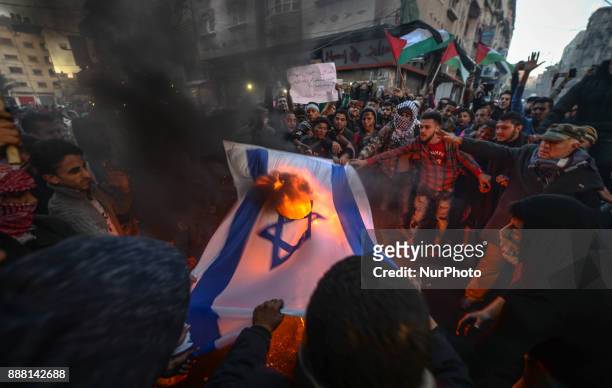 Palestinians burn US and Israeli flags during a protest against the US President decision to recognize Jerusalem as the capital of Israel, in Gaza...