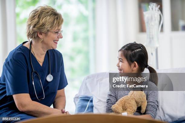 friendly nurse - hospital bed with iv stock pictures, royalty-free photos & images