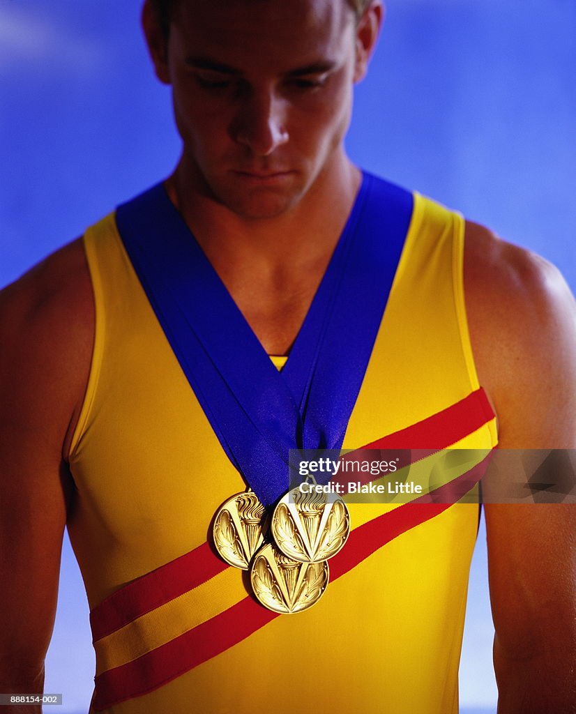 Young athlete with three gold medals