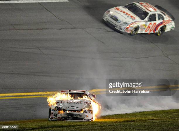 Kertus Davis, driver of the NuTone Heating & Cooling Products Chevrolet, drives on the grass after his car catches fire prior to a crash on track...