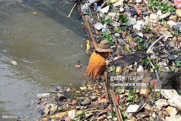 Worker remove garbage from a river in Jakarta on July 4, 2009. About two million tons of hazardous waste and substances are left untreated across the...