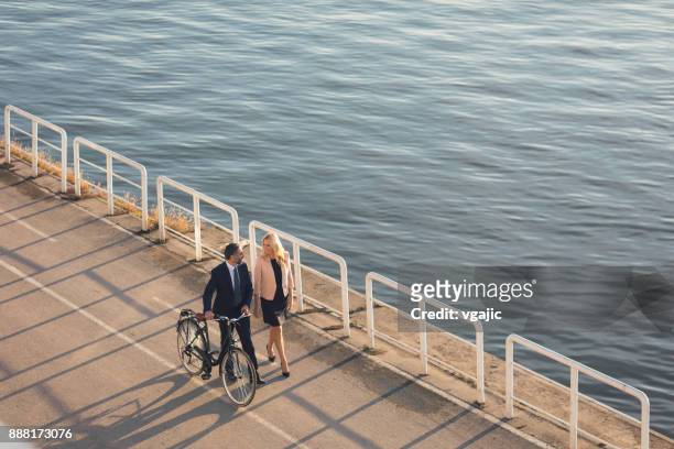 business people going on or off to work bt the river - pedestrian walkway stock pictures, royalty-free photos & images