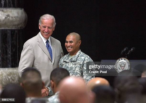 Vice President Joe Biden shakes hands with a US soldier following a US Naturalization ceremony at the al-Faw Palace, a former residence of executed...