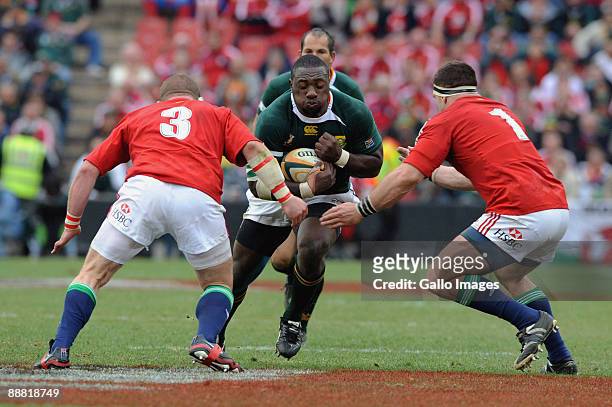 Phil Vickery of the Lions and Andrew Sheridan of the Lions tackle Tendai Myawarira of South Africa during the Third Test match between South Africa...