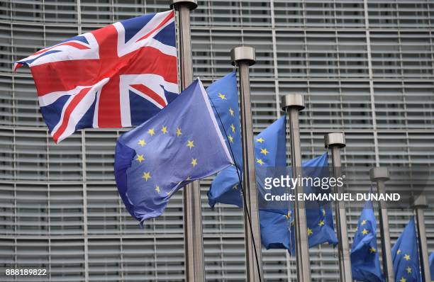 This photo taken on December 8, 2017 at the European Commission in Brussels shows the British national flag raised on a flagpole next flags of the...