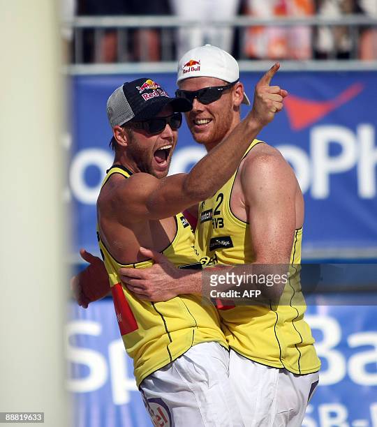 Julius Brink and Jonas Reckermann of Germany react during the match against Ricardo Santos and Emanuel Rego of Brazil at the FIVB Beach Volleyball...