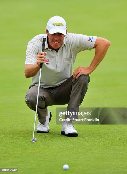 Richard Green of Australia lines up his putt on the sixth hole during the third round of the Open de France ALSTOM at the Le Golf National Golf Club...