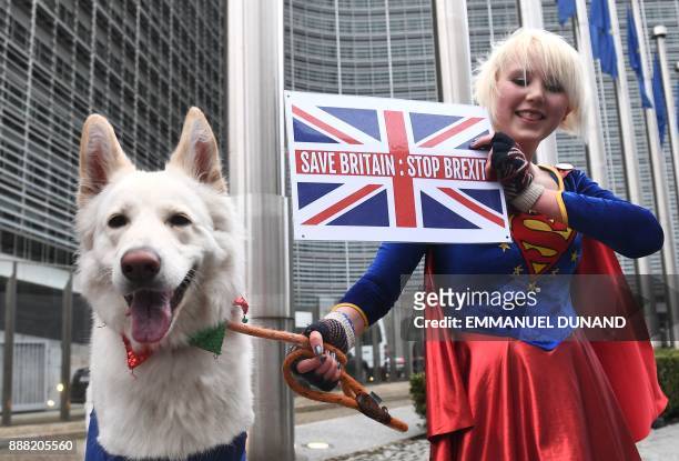 British cartoonist an anti-Brexit activist Madeleine Kay, dressed in a Superwoman costume, poses with a dog in front of European Commission on...