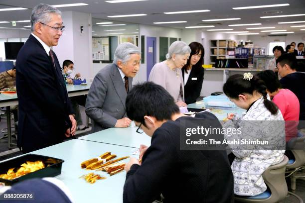 Emperor Akihito and Empress Michiko talk to workers at Mitsukoshi Isetan Soleil Ochiai Center on December 8, 2017 in Tokyo, Japan. The royal couple...