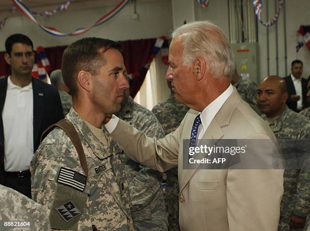 Vice President Joe Biden talks with his son, U.S. Army Capt. Beau Biden at Camp Victory on the outskirts of Baghdad on July 4, 2009. Biden said that...