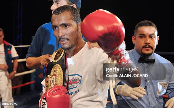 Panamean defendent champion Anselmo Moreno celebrates his victory over French Mahyar Monshipour in their super bantamweight boxing fight, on July 4,...
