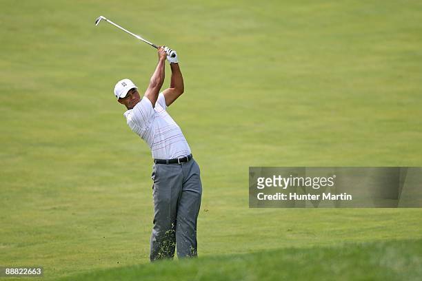 Tiger Woods hits his second shot on the ninth hole during the third round of the AT&T National hosted by Tiger Woods at Congressional Country Club on...