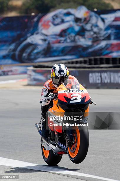 Dani Pedrosa of Spain and Repsol Honda Team lifts the front wheel during qualifying practice for MotoGP World Championship U.S. GP at at Mazda...