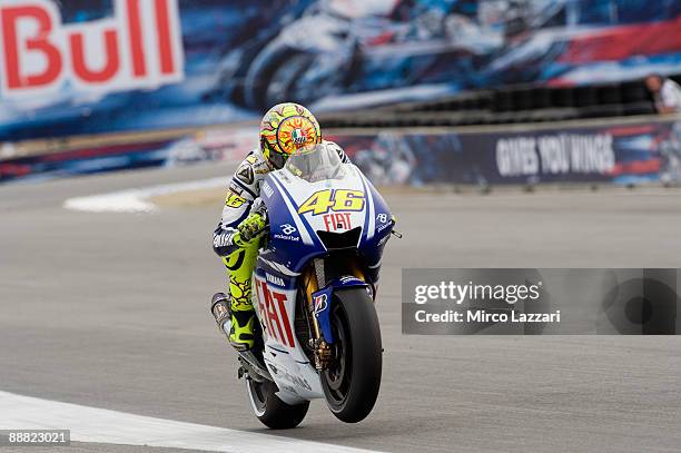 Valentino Rossi of Italy and Fiat Yamaha Team lifts the front wheel during qualifying practice for MotoGP World Championship U.S. GP at at Mazda...