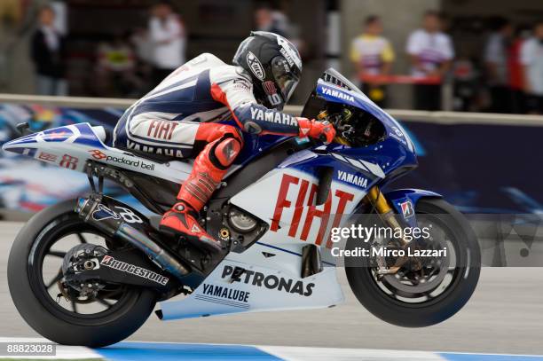Jorge Lorenzo of Spain and Fiat Yamaha Team lifts the front wheel during qualifying practice for MotoGP World Championship U.S. GP at at Mazda...