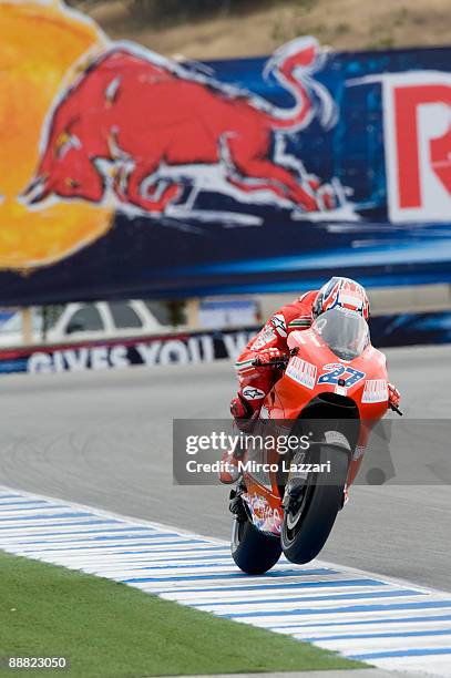 Casey Stoner of Australia and Ducati Malboro Team lifts the front wheel during qualifying practice for MotoGP World Championship U.S. GP at at Mazda...