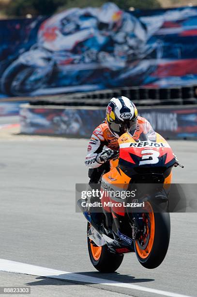 Dani Pedrosa of Spain and Repsol Honda Team lifts the front wheel during qualifying practice for MotoGP World Championship U.S. GP at Mazda Raceway...