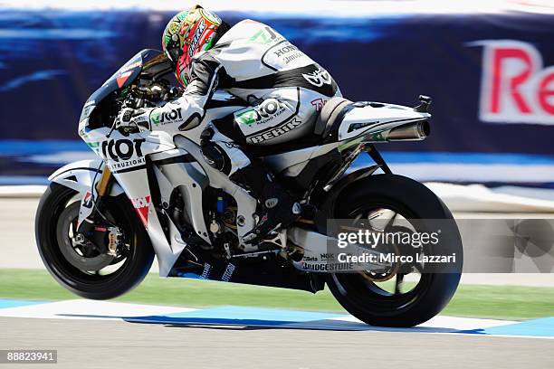 Gabor Talmacsi of Hungary and Scot Racing Team lifts the front wheel during qualifying practice for MotoGP World Championship U.S. GP at Mazda...