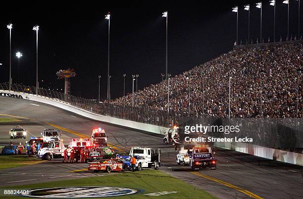 Emergency vehicles tend to Kasey Kahne, driver of the Budweiser Dodge, and Kyle Busch, driver of the Interstate Batteries Toyota, after both cars...