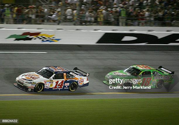 Tony Stewart, driver of the Burger King Chevrolet races Kyle Busch , driver of the Interstate Batteries Toyota during the NASCAR Sprint Cup Series...