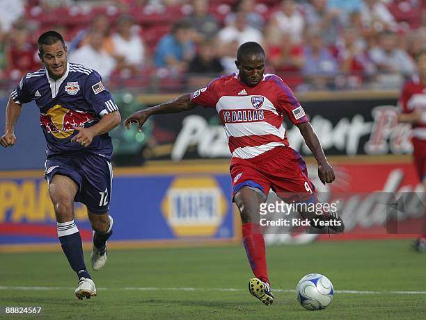 Jeff Cunningham of the FC Dallas shoots the ball while Mike Petke of the New York Red Bulls tries to catch up at Pizza Hut Park on July 4, 2009 in...