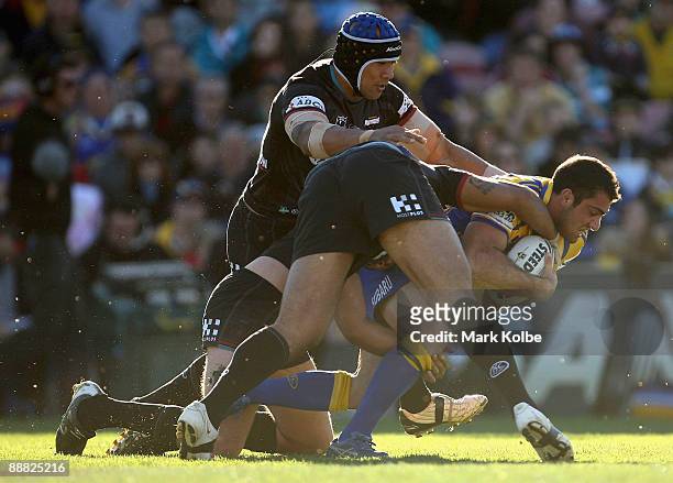 Tim Mannah of the Eels is tackled during the round 17 NRL match between the Penrith Panthers and the Parramatta Eels at CUA Stadium on July 5, 2009...
