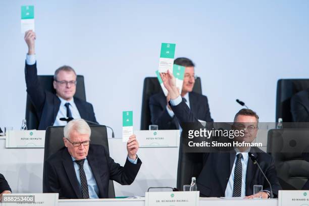 President Reinhard Grindel and DFL League President and DFB Vice President Dr. Reinhard Rauball show their vote cards during the Extraordinary DFB...