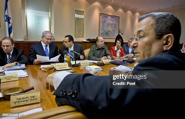 Israeli Prime Minister Benjamin Netanyahu speaks with Cabinet Secretary Tzvi Hauser as Defense Minister Ehud Barak Israel's Minister for Regional...