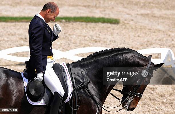 Dressage rider Steffen Peters clenches his fist after winning the Grand Prix Kur event of the CHIO World Equestrian Festival in Aachen, western...