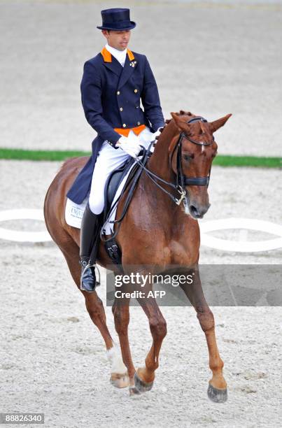 Dutch dressage rider Hans Petr Minderhoud and his horse "Exquis Nadine" compete in the Grand Prix Kur event of the CHIO World Equestrian Festival in...