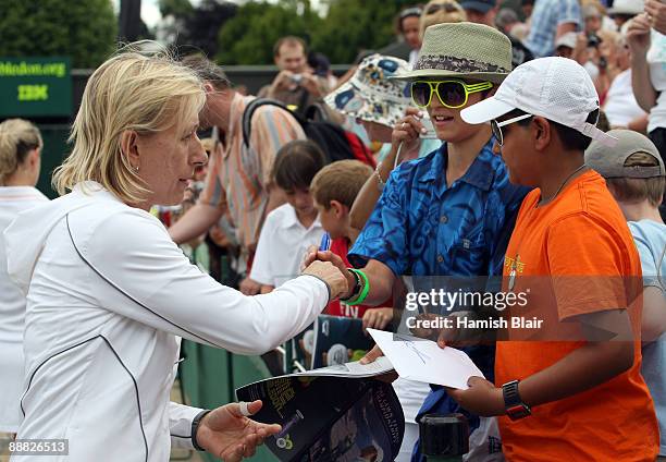 Martina Navratilova of USA signs autographs playing with Helena Sukova of Czech Republic after the ladies' invitation doubles final match against...