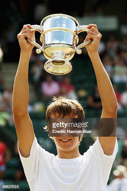 Andrey Kuznetsov of Russia celebrates victory with the trophy after the boy's singles final match against Jordan Cox of USA on Day Thirteen of the...