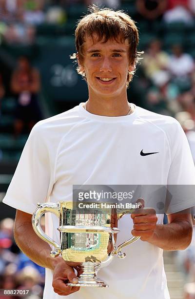 Andrey Kuznetsov of Russia celebrates victory with the trophy after the boy's singles final match against Jordan Cox of USA on Day Thirteen of the...