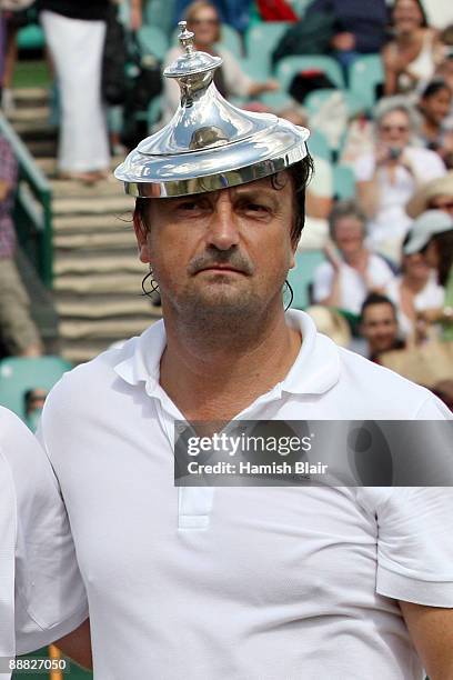 Henri Leconte of France playing with Mansour Bahrami of Iran jokes with the trophy despite defeat to Jeremy Bates of Great Britain and Anders Jarryd...