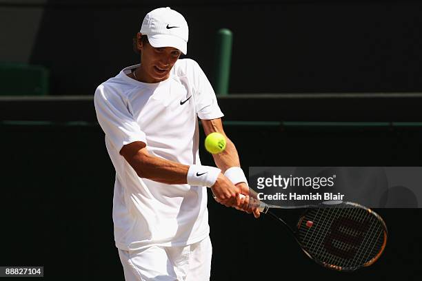 Andrey Kuznetsov of Russia plays a backhand during the boy's singles final match against Jordan Cox of USA on Day Thirteen of the Wimbledon Lawn...
